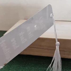 Glossy silver back of engraved bookmark with white tassel